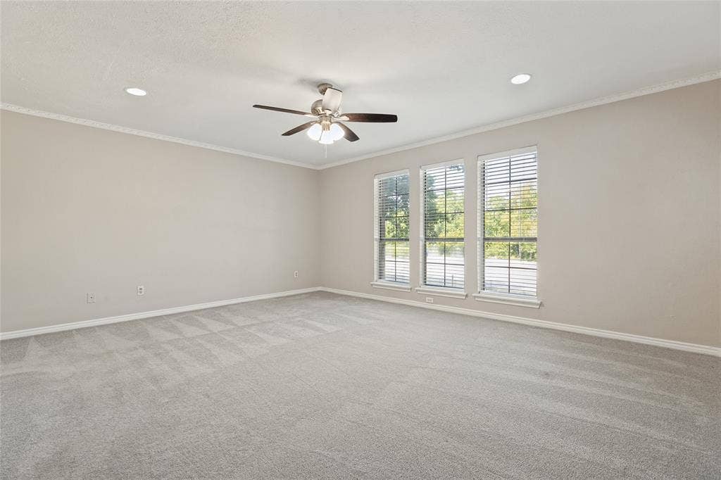 5013 Country Place Drive, Plano, TX 75023 Lovely windows in the primary bedroom , featuring neutral carpeting, recessed lighting, a ceiling fan, crown molding.
