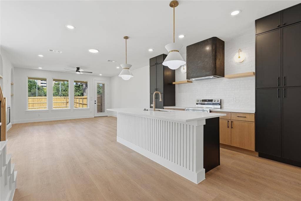 3300 S Harwood Street, Dallas, TX 75215 Open-concept design featuring wood-finish flooring, recessed lighting, and a modern kitchen