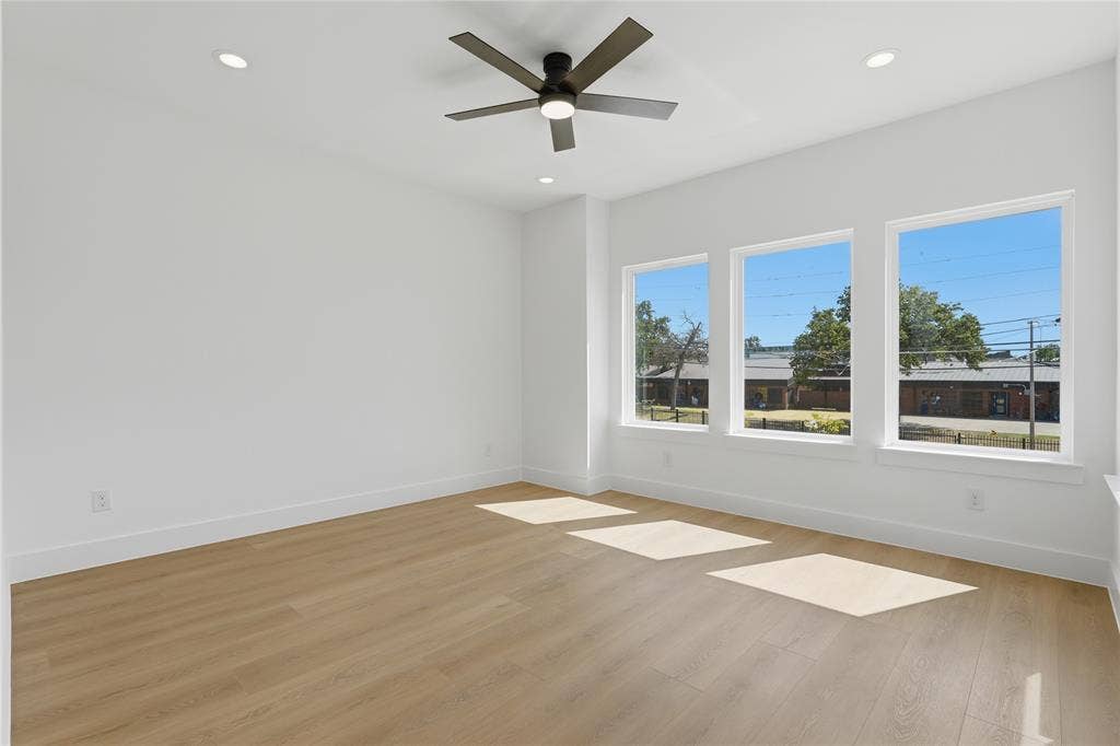 3300 S Harwood Street, Dallas, TX 75215 Wood-finish flooring, recessed lighting, and a ceiling fan with integrated lighting