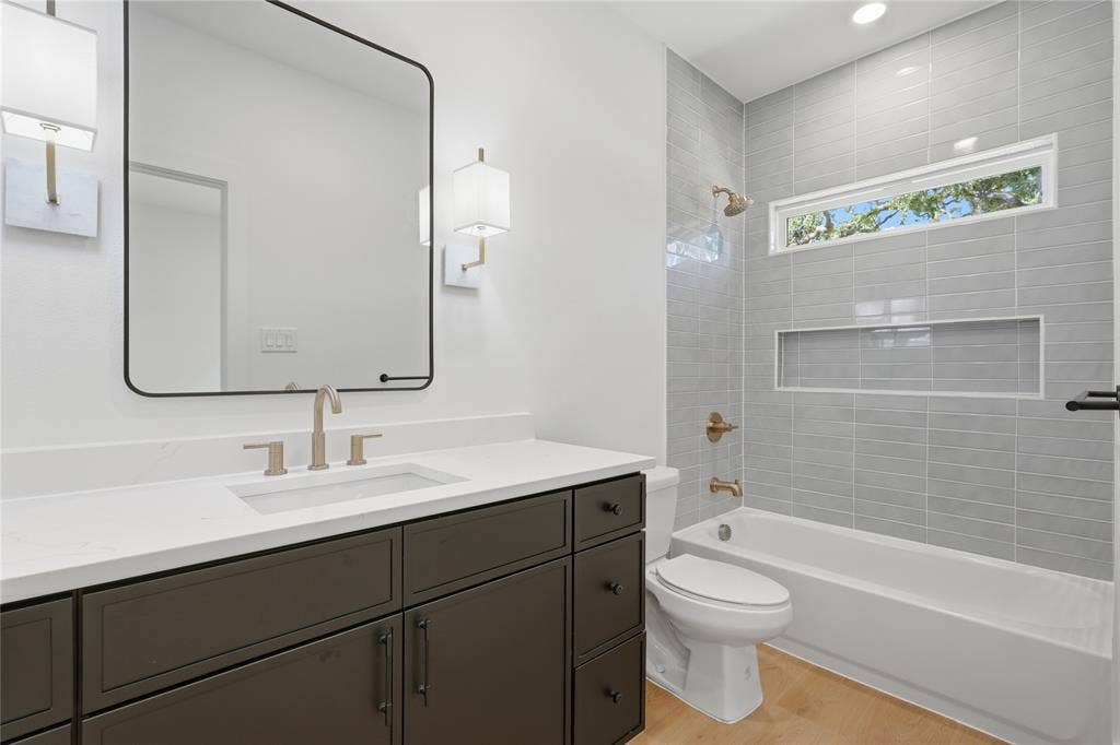 3300 S Harwood Street, Dallas, TX 75215 Dark wood-finish vanity with a white countertop and rectangular undermount sink