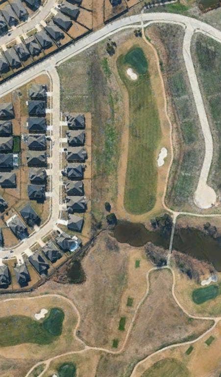 4007 Yellow Jasmine Lane, Heath, TX 75126 Aerial Photograph. Depicting a residential area with housing units and a golf course