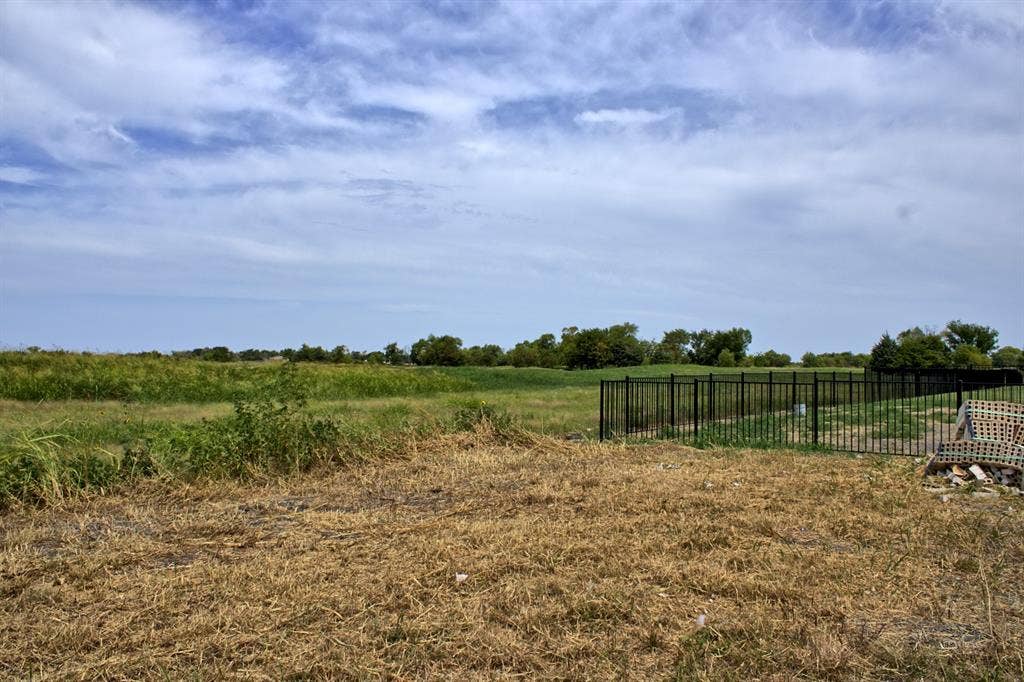4007 Yellow Jasmine Lane, Heath, TX 75126 Expansive outdoor space featuring a large grassy area and a black metal fence