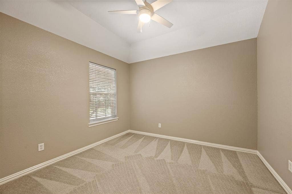 6201 Crator Drive, McKinney, TX 75070 Guest Bedroom upstairs with tray ceiling with an attached ceiling fan, neutral wall paint