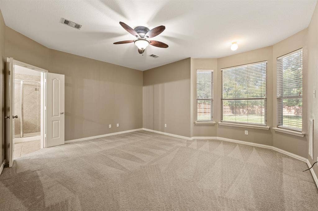 6201 Crator Drive, McKinney, TX 75070 Very spacious primary bedroom with bay windows, fresh paint updated ceiling fan and wonderful natural light