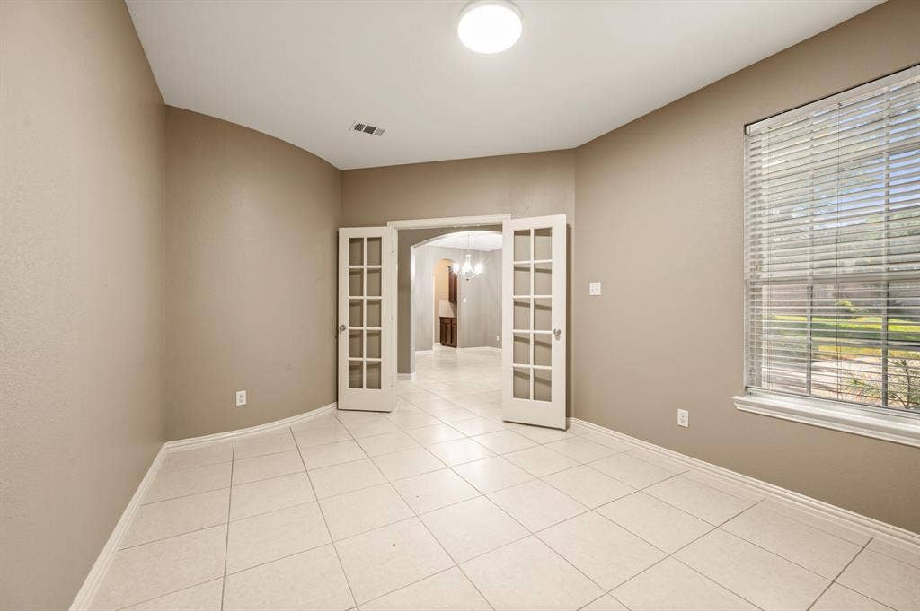6201 Crator Drive, McKinney, TX 75070 Private office with tile flooring, French doors, recessed ceiling light, and neutral wall paint makes it a wonderful place to work from home or to study!