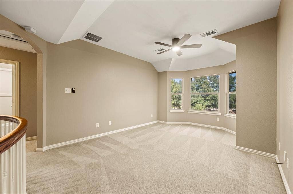 6201 Crator Drive, McKinney, TX 75070 Spacious game room or second leaving upstairs featuring a vaulted ceiling, a ceiling fan, a bay window that lets in amazing natural lighting...This is a great space!