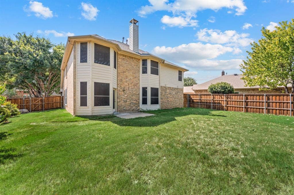6201 Crator Drive, McKinney, TX 75070 Expansive backyard featuring a manicured lawn, board on board wood fencing, and mature trees