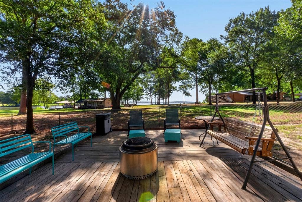 21165 Charina Circle, Chandler, TX 75758 This deck is out on the property under the trees