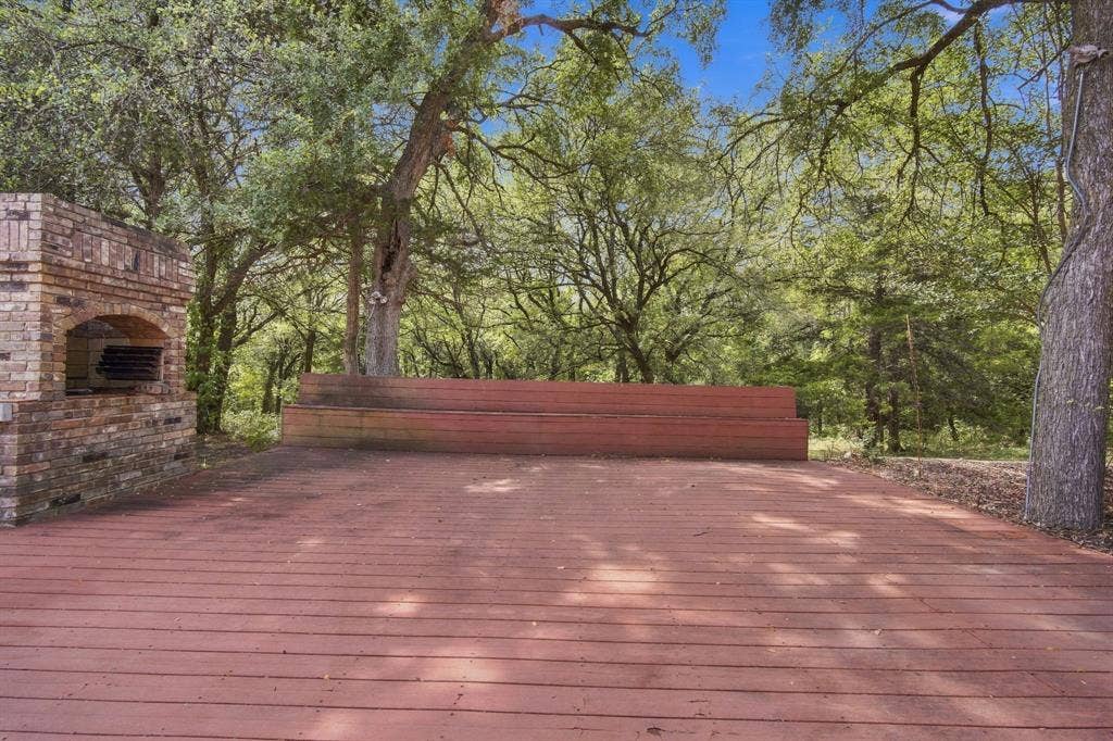 Trex decking with built in bench is a nice place to enntertain next to the brick fireplace.