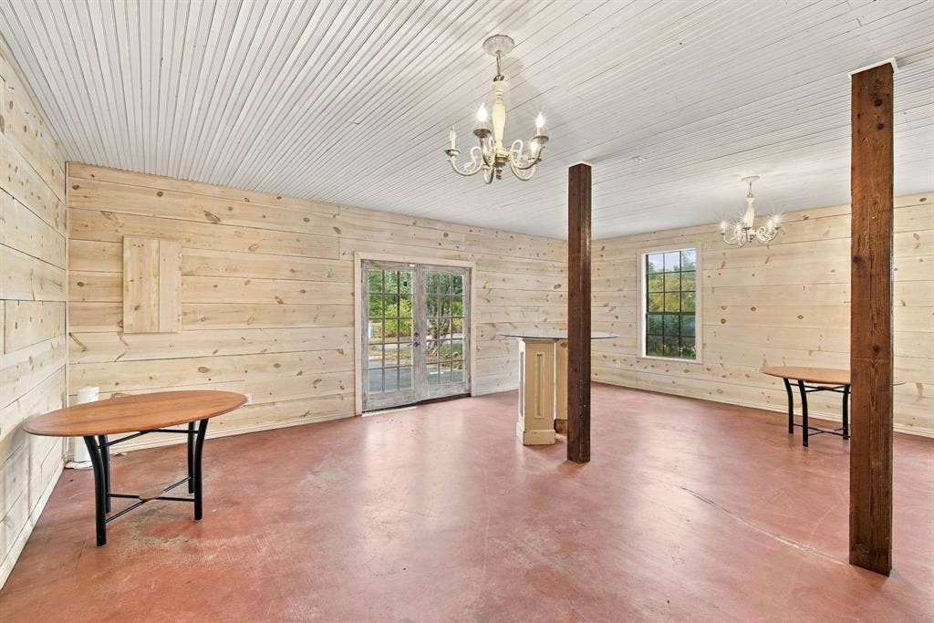 Boutique with shiplap pine walls, chandeliers and stained concrete- opening with double doors to original drive and a walk through door to house.