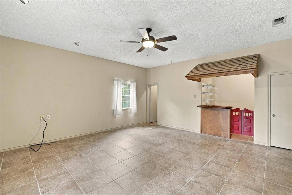 Multi generational living space! Large room with room for Bed and sitting area, wetbar complete with minifridge, sink and countertop space with open shelving, walk in closet and full bath with double doors exiting to backyard.