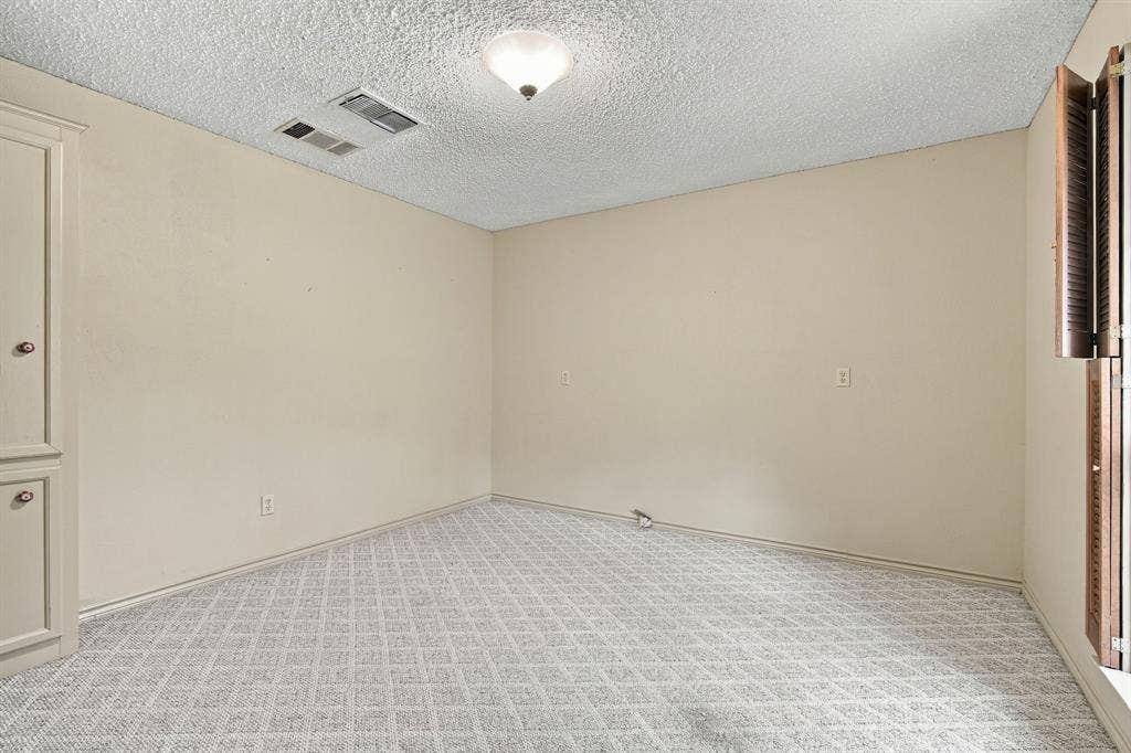 Secondary bedroom located near boutique-used as dressing room. Builtins serve as closet space.