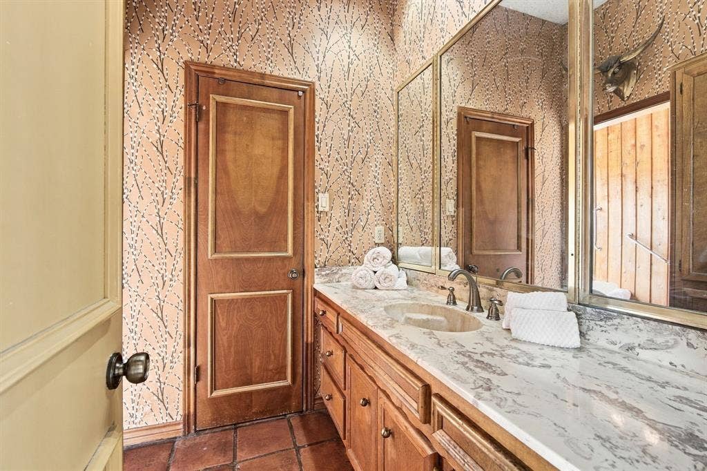 Primary vanities are separate dressing areas with walk in closets, sharing the wet area.