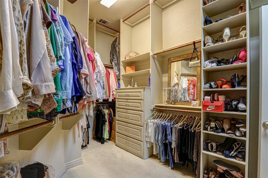 Custom shelving system, built-in dresser, integrated hanging rods, and full-length mirror