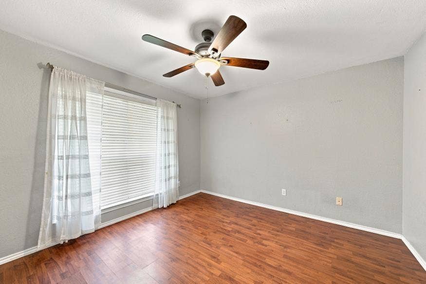 512 Meadowland Drive, Waco, TX 76657 Recessed window with horizontal blinds, wood-finish flooring, ceiling-mounted fan, and textured ceiling