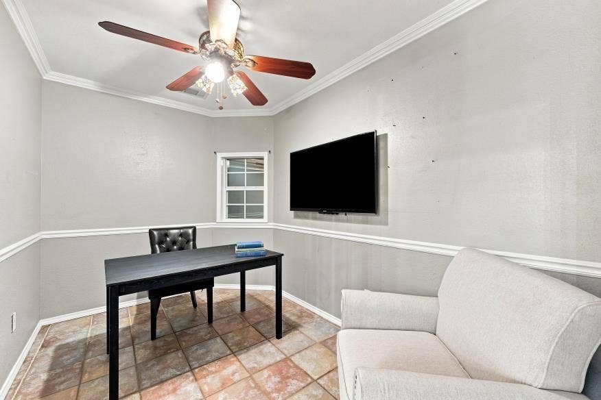 512 Meadowland Drive, Waco, TX 76657 Room featuring a ceiling fan with light fixture, window with grid panes, and a mounted television