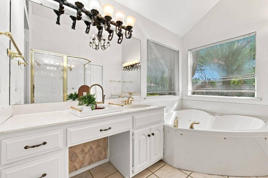 512 Meadowland Drive, Waco, TX 76657 Dual vanity with white cabinetry, ample counter space, and a built-in makeup area