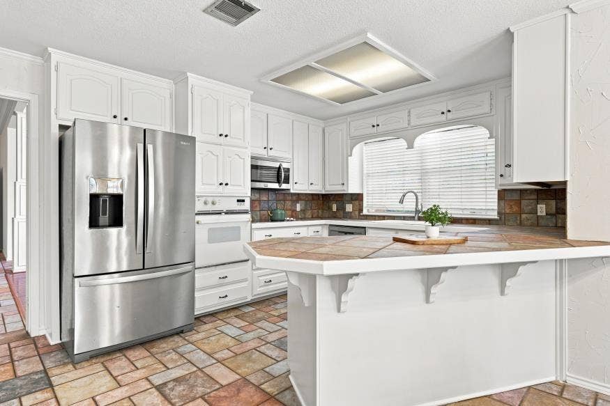 512 Meadowland Drive, Waco, TX 76657 White cabinetry and a stainless steel refrigerator