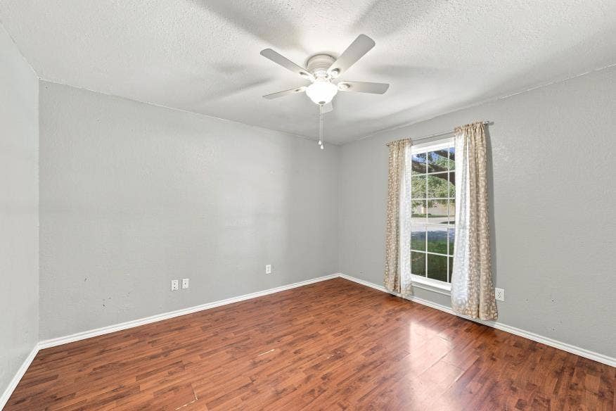 512 Meadowland Drive, Waco, TX 76657 Wood-finish flooring with a ceiling fan and overhead lighting