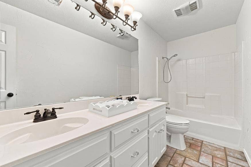 512 Meadowland Drive, Waco, TX 76657 Bright, spa-inspired bathroom featuring a dual-sink vanity with ample storage, quartz countertop, and brushed nickel hardware