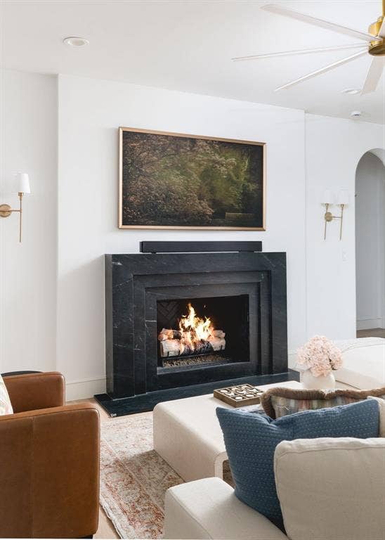 Black stone fireplace surround with a dark herringbone interior