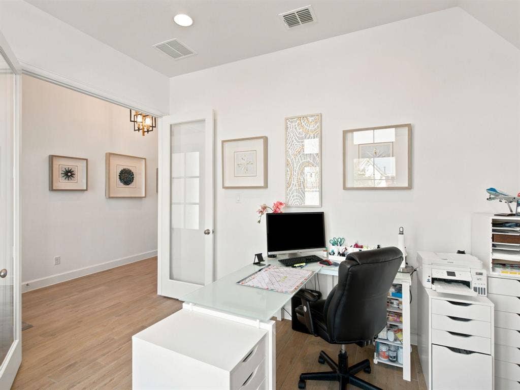 Vaulted ceiling with recessed lighting, wood-finish flooring, and a glass-paneled entry door