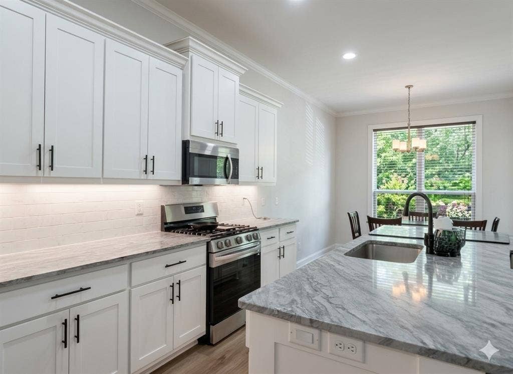 11034 Oak Springs Cove, Tyler, TX 75703 White shaker cabinetry with matte black hardware, stainless steel appliances, grey veined countertops, subway tile backsplash, and recessed lighting