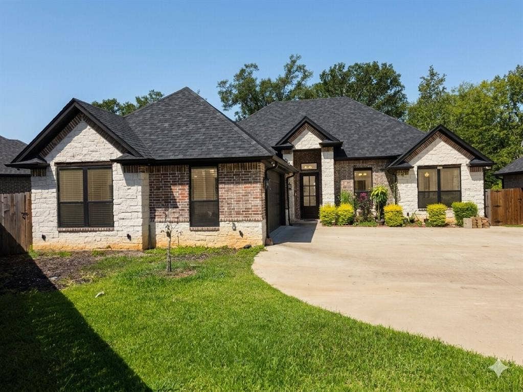 11034 Oak Springs Cove, Tyler, TX 75703 Brick and stone exterior with dark-framed windows