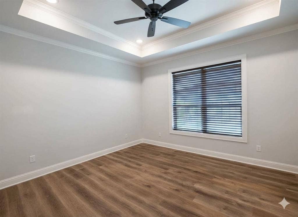 11034 Oak Springs Cove, Tyler, TX 75703 Tray ceiling with recessed lighting, crown molding, wood-finish flooring, and a ceiling fan