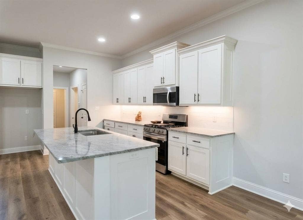 11034 Oak Springs Cove, Tyler, TX 75703 White shaker cabinetry with dark hardware, granite countertops, wood-finish flooring, and a stainless steel appliance suite