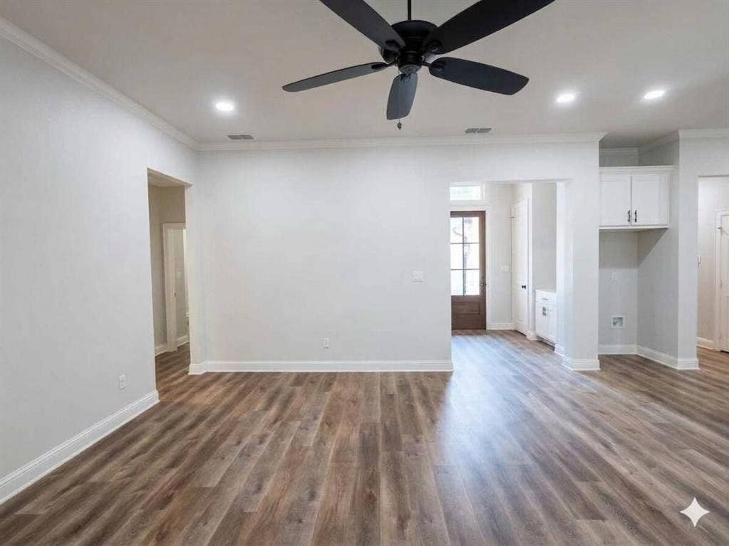 11034 Oak Springs Cove, Tyler, TX 75703 Wood-finish flooring throughout, recessed ceiling lighting, a dark-toned ceiling fan, crown molding, and built-in cabinetry