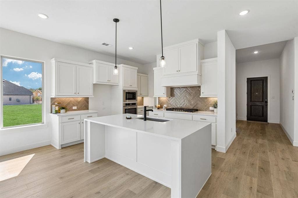 1820 Vetiver Glow Drive, Celina, TX 75009 Light, bright and airy, this open concept kitchen-dining-family room is everything you have been searching for!