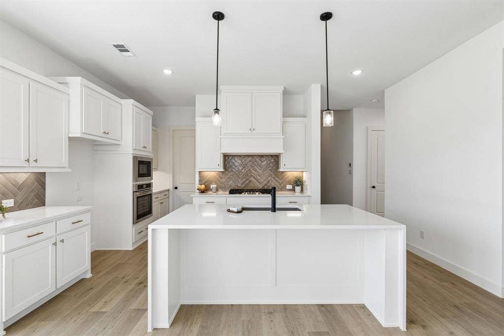 1820 Vetiver Glow Drive, Celina, TX 75009 The spacious kitchen island is an ideal place for friends and family to gather round!