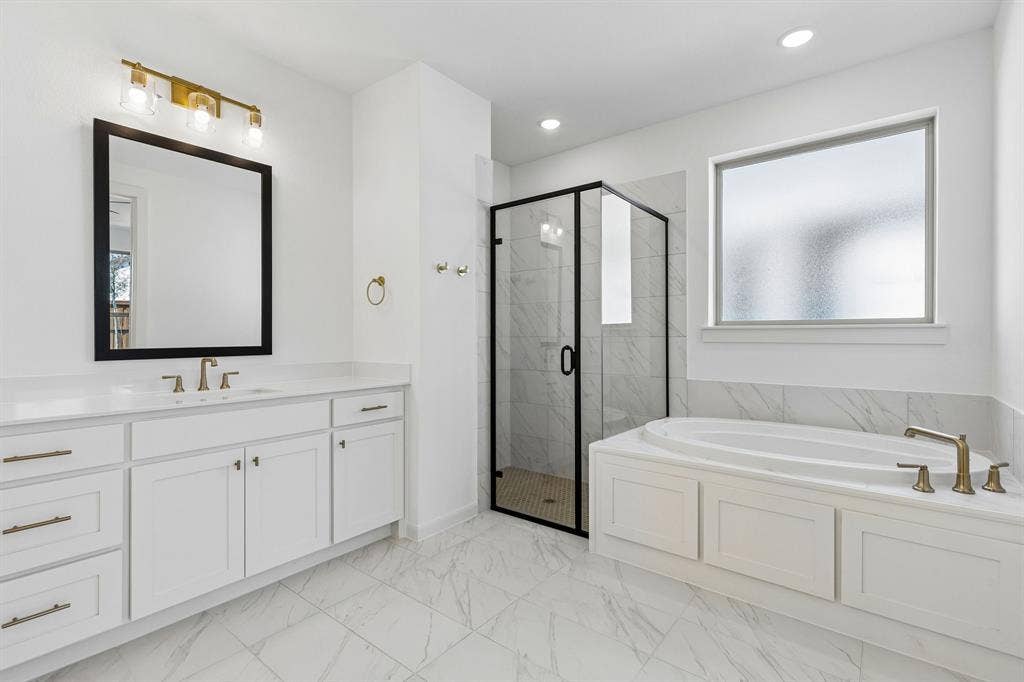 1820 Vetiver Glow Drive, Celina, TX 75009 This fantastic owner's bath offers a spacious walk in shower combined with a wonderful soaking tub.