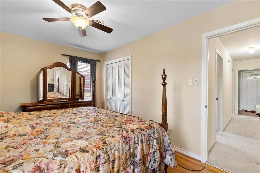 1013 Bandera Lane, Garland, TX 75040 Ceiling fan with integrated lighting, wood-finish flooring, and bi-fold closet doors
