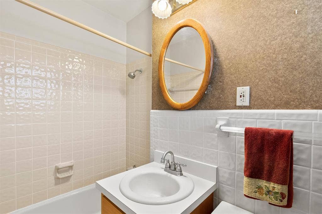 1013 Bandera Lane, Garland, TX 75040 Shower/tub combination with light-toned wall tiling