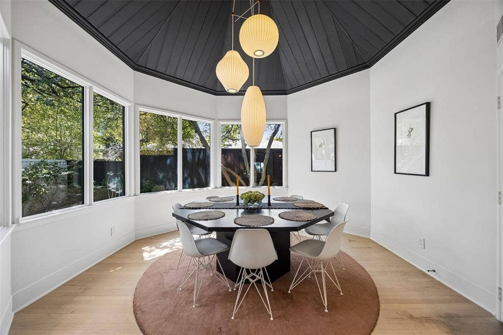 The dramatic formal dining room, with a vaulted ceiling, prominent windows, built-in shelving and generous storage create a memorable setting for entertaining.