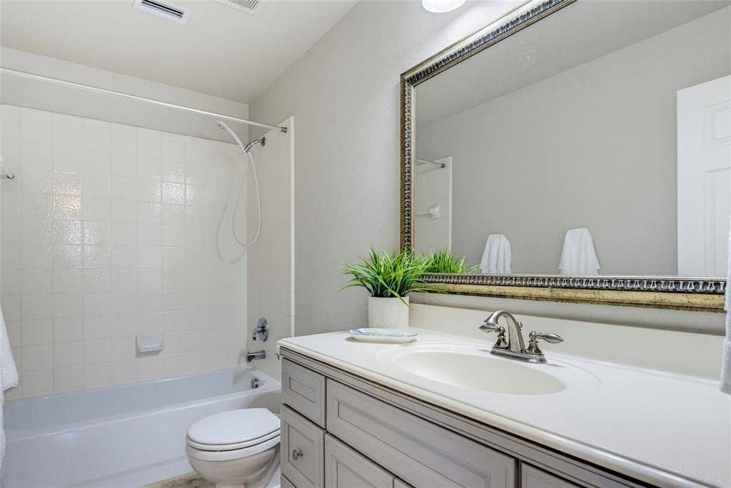 3408 Loblolly Lane, McKinney, TX 75070 Bathroom updates include the wood vanity, fresh paint, and tile flooring.