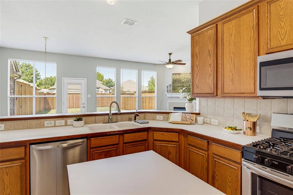 3408 Loblolly Lane, McKinney, TX 75070 The kitchen is open to the breakfast room and living room and enjoys views of the backyard as well.
