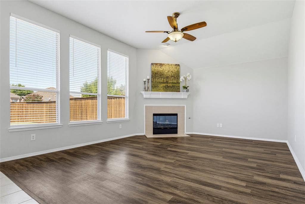 3408 Loblolly Lane, McKinney, TX 75070 A corner fireplace creates a focal point for this family room.