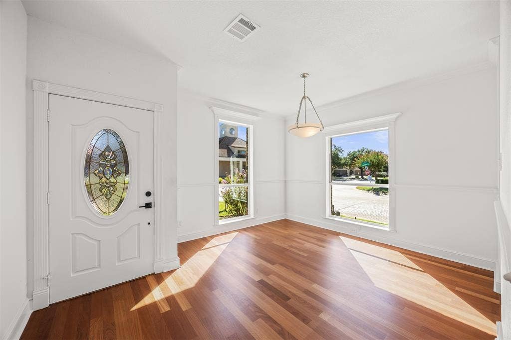 4203 N Capistrano Drive, Dallas, TX 75287 Dining Room with Brazilian Cherry floors installed with custom baseboards and trim