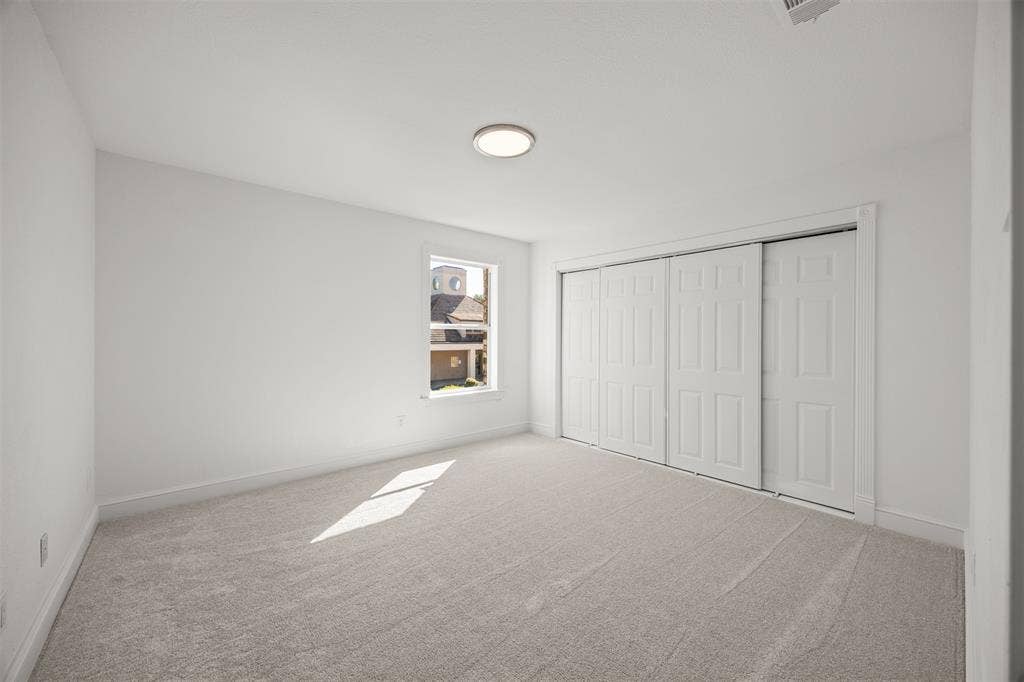 4203 N Capistrano Drive, Dallas, TX 75287 Bedroom 2. Closet has 9' sliding door system, interior shelving, LED lighting and new Shaw Carpeting and Pad installed.