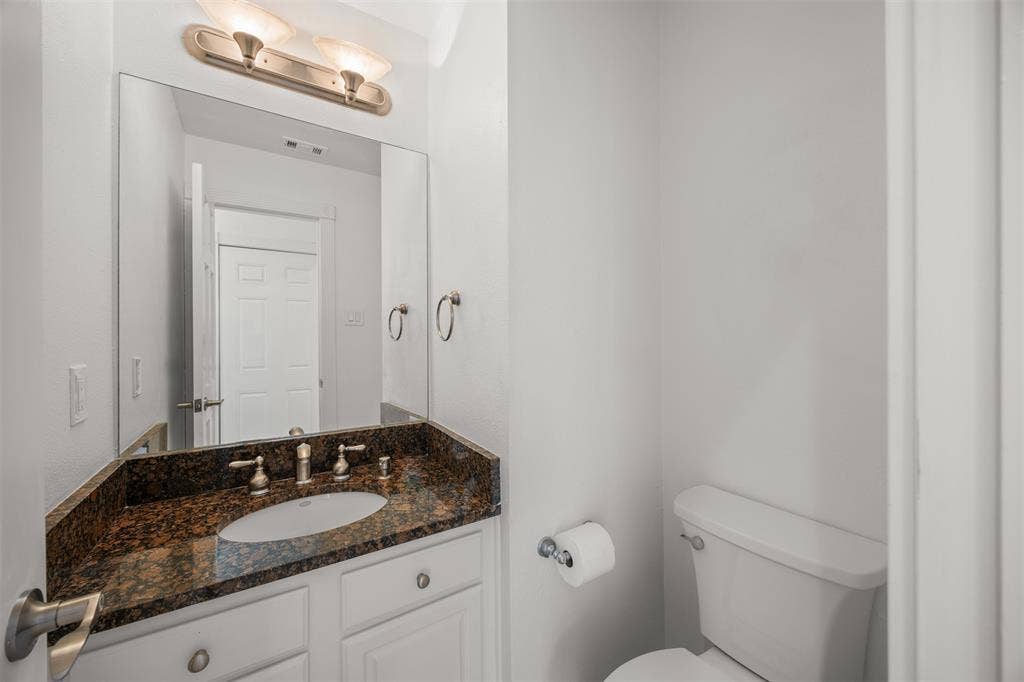 4203 N Capistrano Drive, Dallas, TX 75287 First floor half bath with granite countertop, brushed nickel faucet, soft close cabinet doors and new Kohler toilet. Floor is Travertine. All doors are solid wood, six panel with new brushed nickel latches and hinges installed. These same finishes are in place throughout the home.