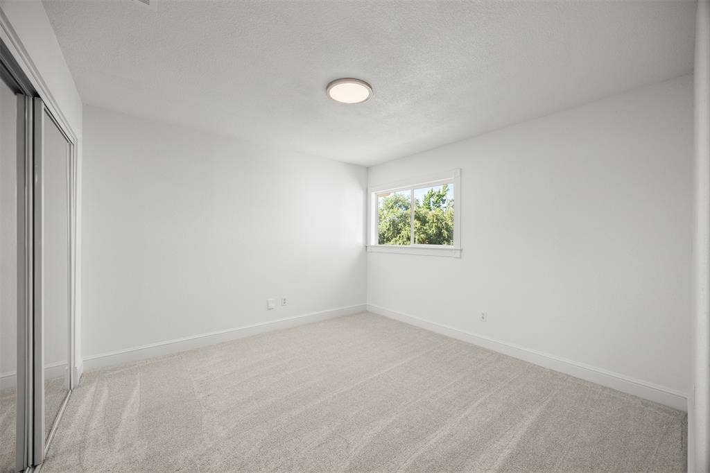 4203 N Capistrano Drive, Dallas, TX 75287 Bedroom 3. Closet has sliding mirrored doors with interior shelving. New Shaw Carpeting & Pad Installed. LED Lighting.