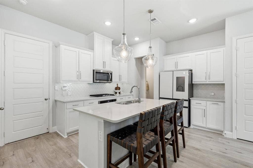 12952 Wymeth Drive, Farmers Branch, TX 75234 Spacious kitchen with island, smart fridge, an oven that has barely been used and a great coffee/tea nook.