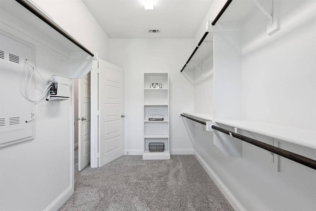 12952 Wymeth Drive, Farmers Branch, TX 75234 One of two walk-in closets in the primary bedroom