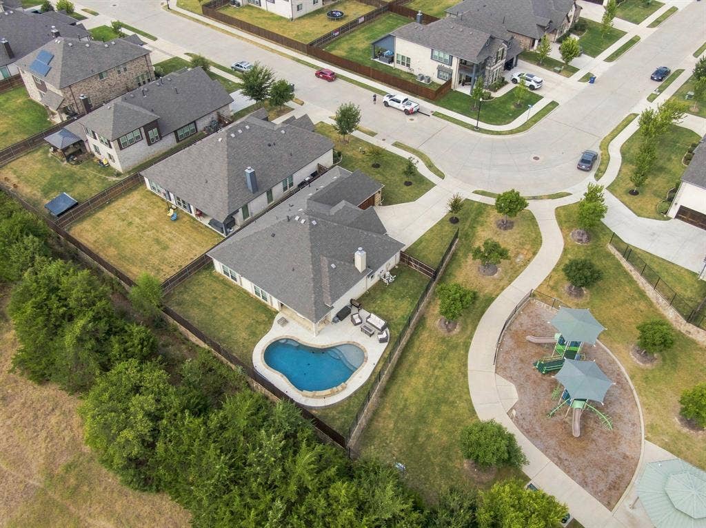 This unbeatable property is nestled on a lot directly adjacent to the community trail and playground