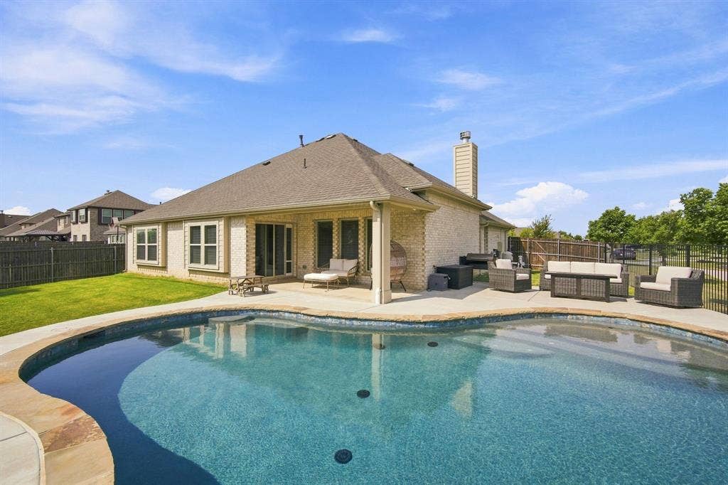 Access the covered rear patio seamlessly through sliding glass doors right off the dining area