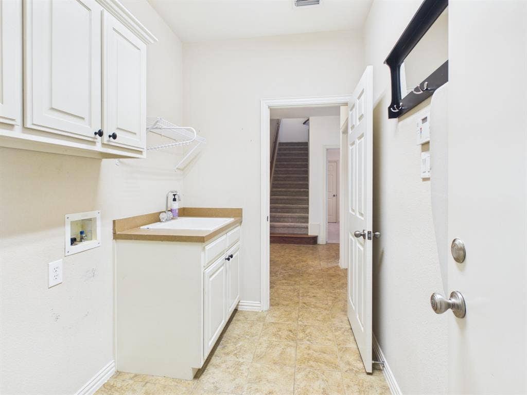 Spacious laundry space with sink