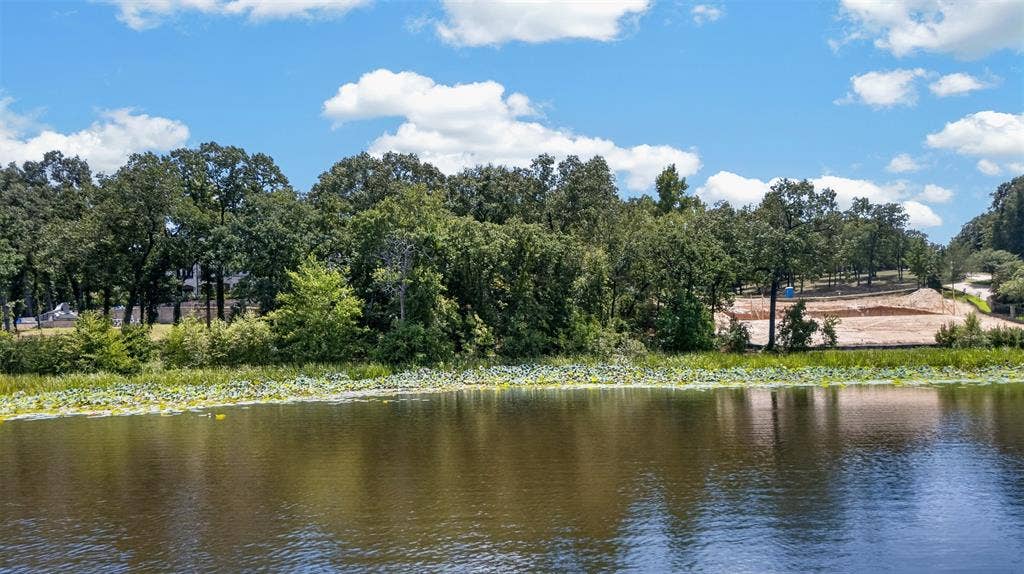 4513 Cascades Shoreline Drive, Tyler, TX 75709 Waterfront property featuring a wooded shoreline and cleared land for development